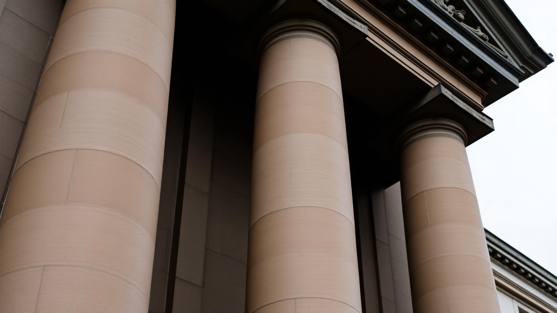 Sandstone columns of a Leeds civic building under overcast light